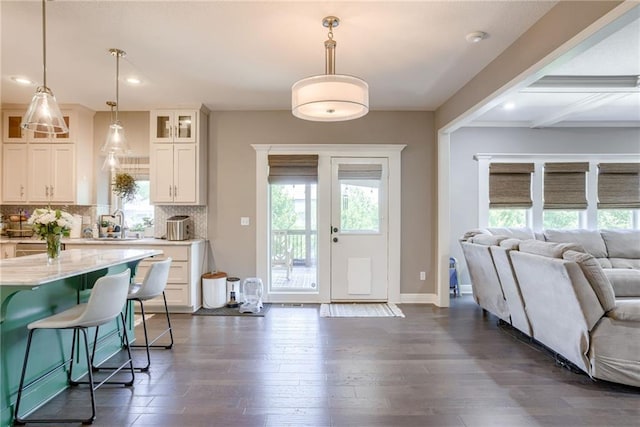 8721 N Mersington Ave, Kansas City, MO 64156 - kitchen featuring open floor plan, glass insert cabinets, dark wood finished floors, tasteful backsplash, and recessed lighting