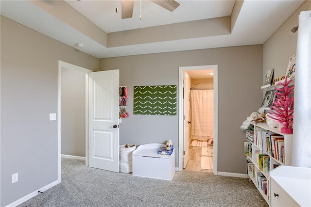 8721 N Mersington Ave, Kansas City, MO 64156 - bedroom with light carpet, a tray ceiling, and ensuite bath