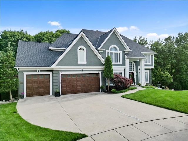 1329 NW 47th St, Kansas City, MO 64116 - view of front of home with driveway, a front yard, a shingled roof, an attached garage, and stucco siding