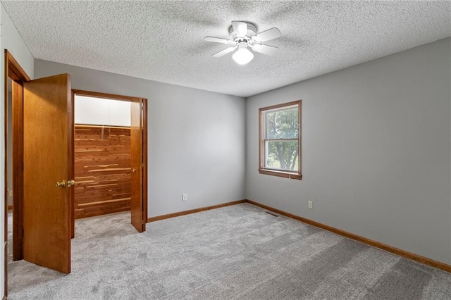 12 SW 365th Rd, Warrensburg, MO 64093 - unfurnished bedroom featuring a textured ceiling, carpet, a ceiling fan, and a closet