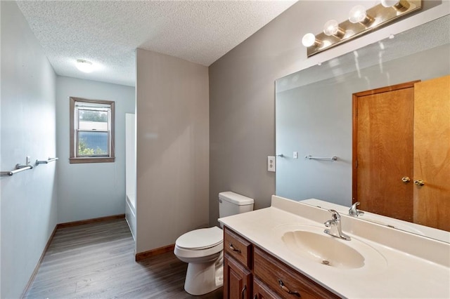 12 SW 365th Rd, Warrensburg, MO 64093 - full bathroom featuring wood finished floors, vanity, and a textured ceiling