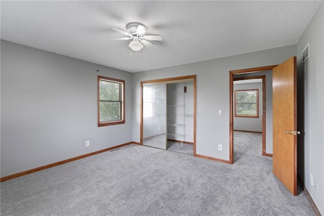12 SW 365th Rd, Warrensburg, MO 64093 - unfurnished bedroom with carpet, a textured ceiling, a closet, and a ceiling fan