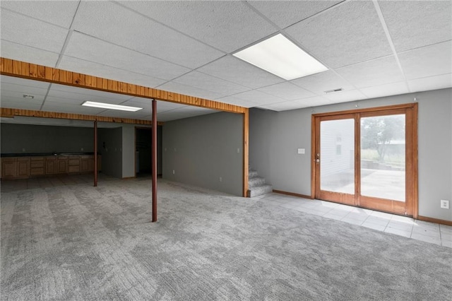 12 SW 365th Rd, Warrensburg, MO 64093 - basement featuring carpet floors, a drop ceiling, stairway, and tile patterned floors