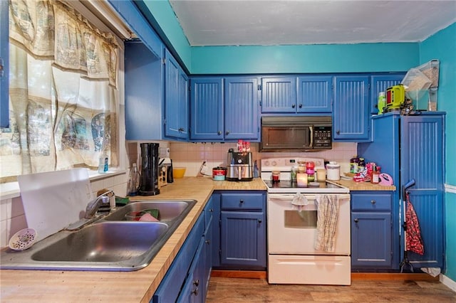 1405 S Vine St, Holden, MO 64040 - kitchen featuring black microwave, white electric range oven, blue cabinetry, and light countertops