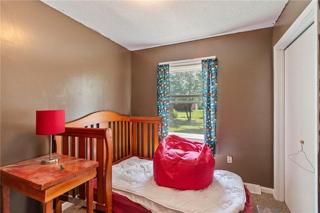 1405 S Vine St, Holden, MO 64040 - carpeted bedroom with a textured ceiling