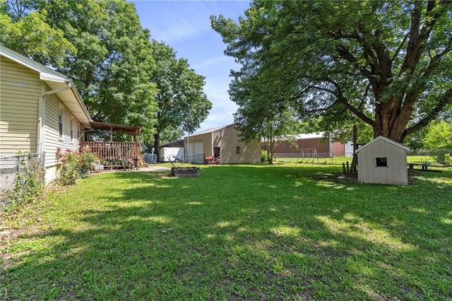 1405 S Vine St, Holden, MO 64040 - view of yard featuring a storage shed and a wooden deck