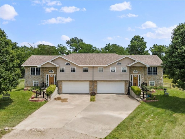 131 NW 171st Rd, Warrensburg, MO 64093 - raised ranch featuring stone siding, a garage, concrete driveway, and a front lawn