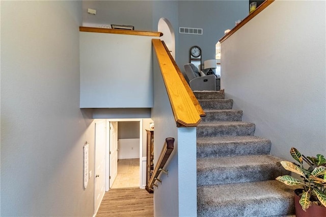 131 NW 171st Rd, Warrensburg, MO 64093 - stairway featuring wood finished floors and arched walkways