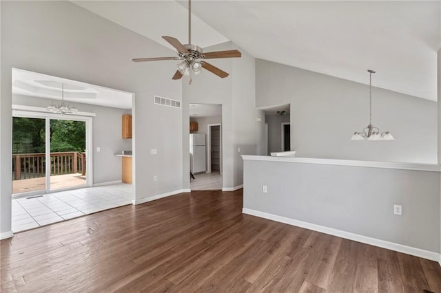 131 NW 171st Rd, Warrensburg, MO 64093 - unfurnished living room featuring a chandelier, ceiling fan, wood finished floors, and high vaulted ceiling