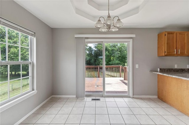 131 NW 171st Rd, Warrensburg, MO 64093 - unfurnished dining area with a chandelier, plenty of natural light, and light tile patterned flooring