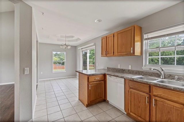 131 NW 171st Rd, Warrensburg, MO 64093 - kitchen featuring white dishwasher, a chandelier, light tile patterned floors, a peninsula, and brown cabinets