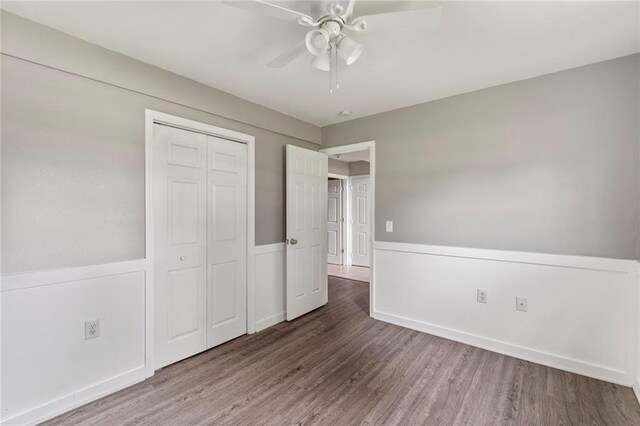 131 NW 171st Rd, Warrensburg, MO 64093 - unfurnished bedroom featuring wood finished floors, a closet, and ceiling fan