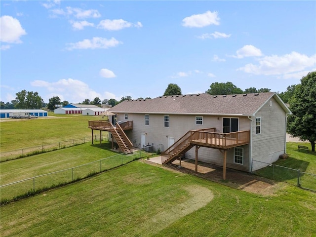 131 NW 171st Rd, Warrensburg, MO 64093 - back of house with stairway, a wooden deck, and a fenced backyard