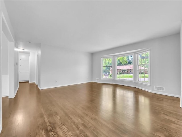 15378 E 45th St S, Independence, MO 64055 - unfurnished living room featuring wood finished floors and baseboards