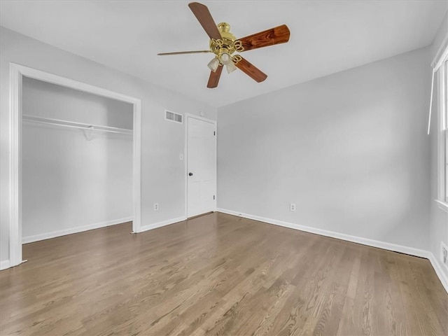 15378 E 45th St S, Independence, MO 64055 - unfurnished bedroom with baseboards, wood finished floors, a closet, and ceiling fan