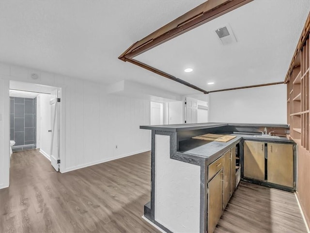 15378 E 45th St S, Independence, MO 64055 - kitchen featuring wood finished floors, dark countertops, a sink, a peninsula, and baseboards