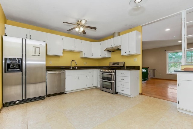 19218 E 6th St N, Independence, MO 64056 - kitchen with stainless steel appliances, under cabinet range hood, dark countertops, ceiling fan, and recessed lighting