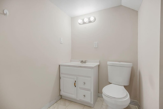 19218 E 6th St N, Independence, MO 64056 - half bath with vanity, toilet, marble look tile flooring, baseboards, and lofted ceiling