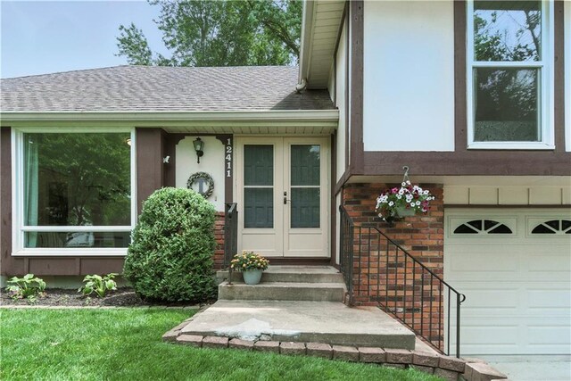 12411 W 100th St, Lenexa, KS 66215 - property entrance with brick siding, roof with shingles, and a garage