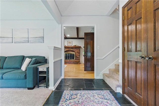 12411 W 100th St, Lenexa, KS 66215 - entrance foyer featuring stone tile flooring, stairway, and a fireplace