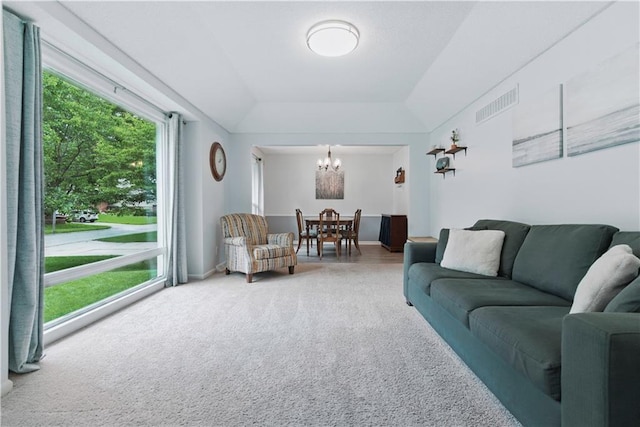 12411 W 100th St, Lenexa, KS 66215 - living room featuring carpet, a chandelier, and a raised ceiling