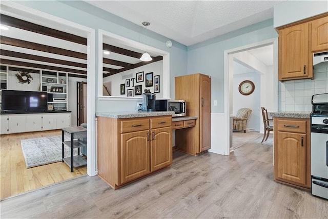 12411 W 100th St, Lenexa, KS 66215 - kitchen with stainless steel appliances, light wood finished floors, beamed ceiling, tasteful backsplash, and hanging light fixtures