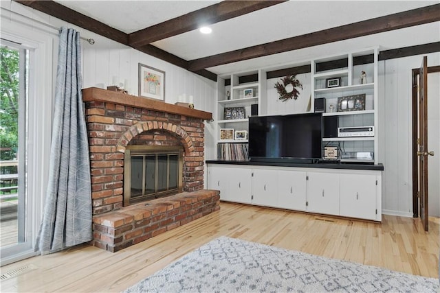 12411 W 100th St, Lenexa, KS 66215 - living area featuring a fireplace, wood finished floors, and beam ceiling