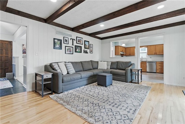 12411 W 100th St, Lenexa, KS 66215 - living area with beamed ceiling and light wood finished floors