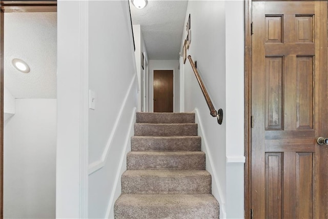 12411 W 100th St, Lenexa, KS 66215 - staircase with a textured ceiling
