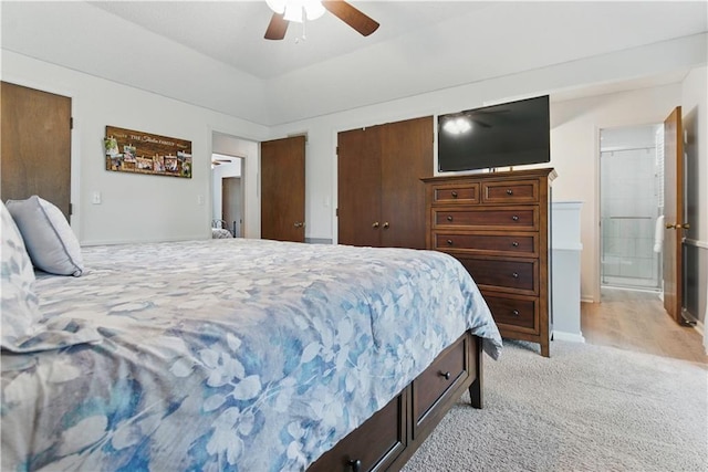 12411 W 100th St, Lenexa, KS 66215 - bedroom featuring light colored carpet, connected bathroom, a ceiling fan, and a closet