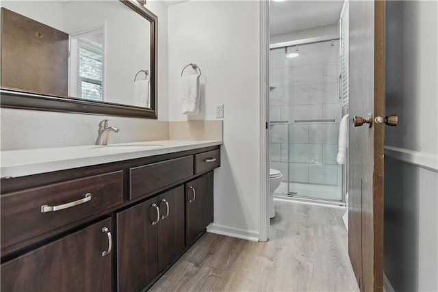 12411 W 100th St, Lenexa, KS 66215 - bathroom with wood finished floors, vanity, and a shower stall