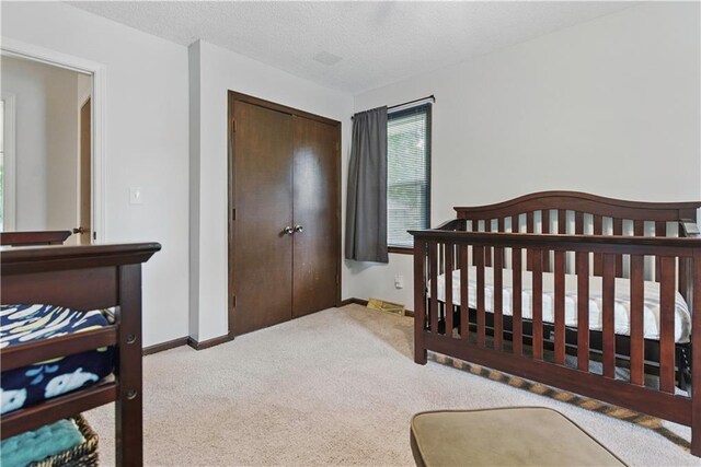 12411 W 100th St, Lenexa, KS 66215 - bedroom with a closet, carpet floors, and a textured ceiling