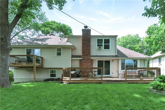 12411 W 100th St, Lenexa, KS 66215 - rear view of house featuring a chimney, a lawn, a wooden deck, and roof with shingles