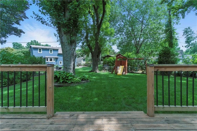 12411 W 100th St, Lenexa, KS 66215 - view of green lawn featuring a wooden deck and a playground