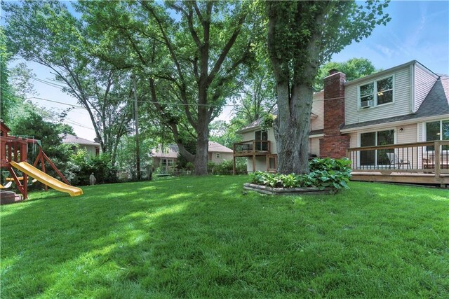 12411 W 100th St, Lenexa, KS 66215 - view of grassy yard featuring a playground and a deck