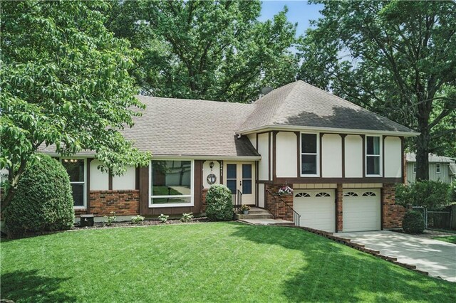 12411 W 100th St, Lenexa, KS 66215 - tri-level home featuring brick siding, a shingled roof, an attached garage, concrete driveway, and a front yard