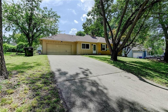 7907 Elm Ave, Raytown, MO 64138 - ranch-style house featuring an attached garage, driveway, a front lawn, and board and batten siding