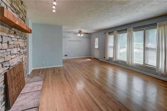 7907 Elm Ave, Raytown, MO 64138 - unfurnished living room with ceiling fan and wood finished floors