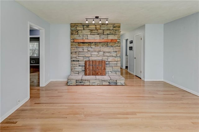 7907 Elm Ave, Raytown, MO 64138 - unfurnished living room featuring wood finished floors and baseboards