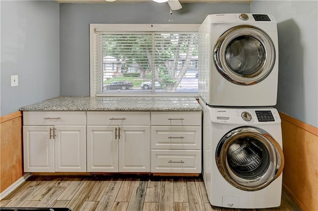 7907 Elm Ave, Raytown, MO 64138 - laundry room featuring stacked washer / drying machine, cabinet space, a ceiling fan, and light wood-style floors