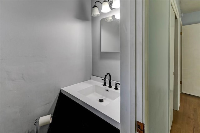 7907 Elm Ave, Raytown, MO 64138 - bathroom featuring vanity and wood finished floors