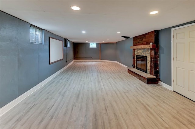 7907 Elm Ave, Raytown, MO 64138 - basement featuring wood finished floors, a fireplace, and recessed lighting