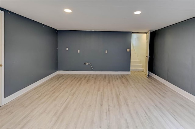 7907 Elm Ave, Raytown, MO 64138 - unfurnished room featuring light wood-type flooring, recessed lighting, and stairway