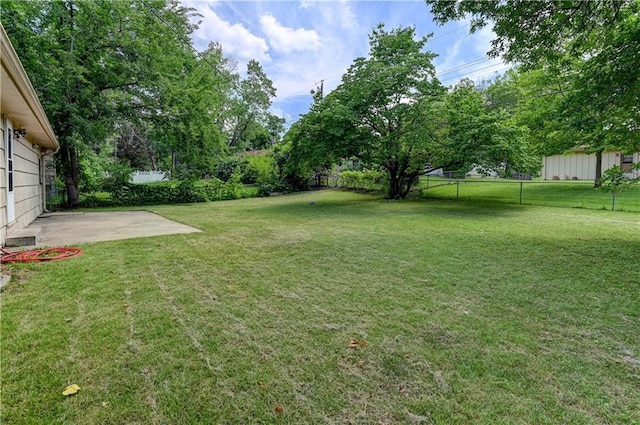 7907 Elm Ave, Raytown, MO 64138 - fenced backyard with a patio area