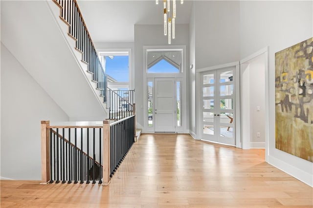 15601 Catalina St, Overland Park, KS 66224 - foyer featuring a high ceiling, hardwood / wood-style flooring, french doors, and stairway