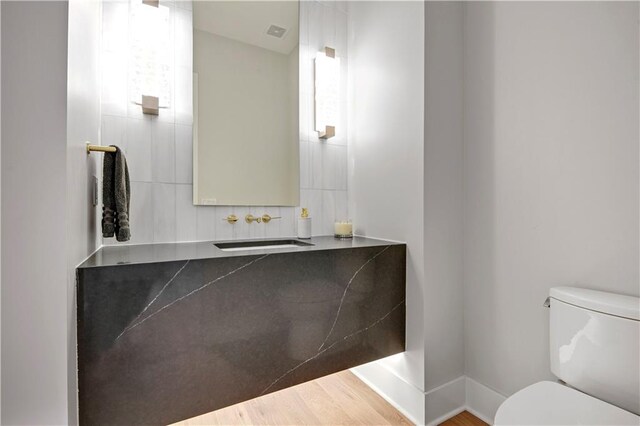 15601 Catalina St, Overland Park, KS 66224 - bathroom with toilet, vanity, and wood finished floors