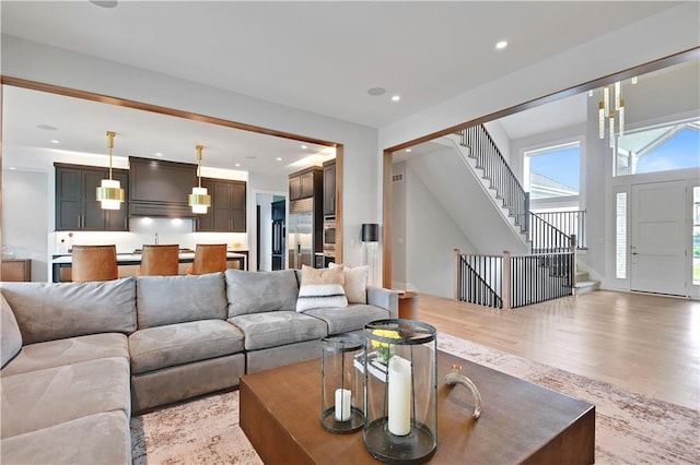 15601 Catalina St, Overland Park, KS 66224 - living room with stairs, wood finished floors, and recessed lighting