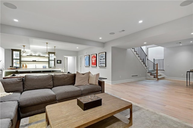 15601 Catalina St, Overland Park, KS 66224 - living room with light wood finished floors, stairs, recessed lighting, and baseboards
