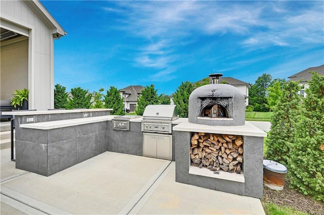 15601 Catalina St, Overland Park, KS 66224 - view of patio / terrace featuring an outdoor brick fireplace