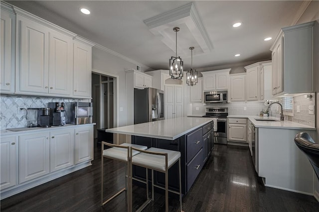23856 W 124th Ct, Olathe, KS 66061 - kitchen with appliances with stainless steel finishes, crown molding, a center island, a breakfast bar area, and light countertops